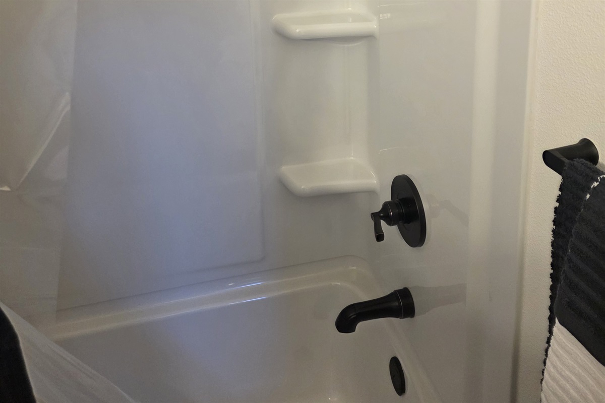 Bathroom includes a vanity, toilet, and shower/tub combo.