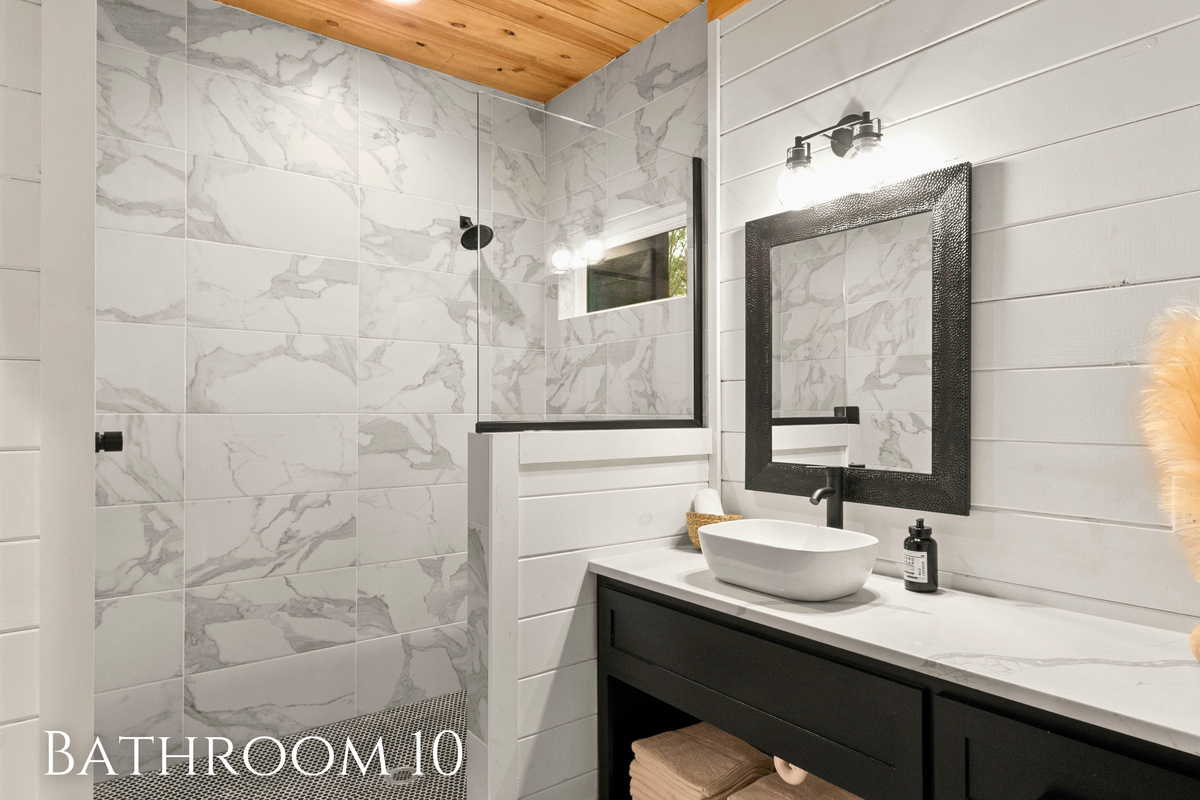 A walk-in shower featuring eye-catching patterned tiles that give the space a vibrant and unique character.