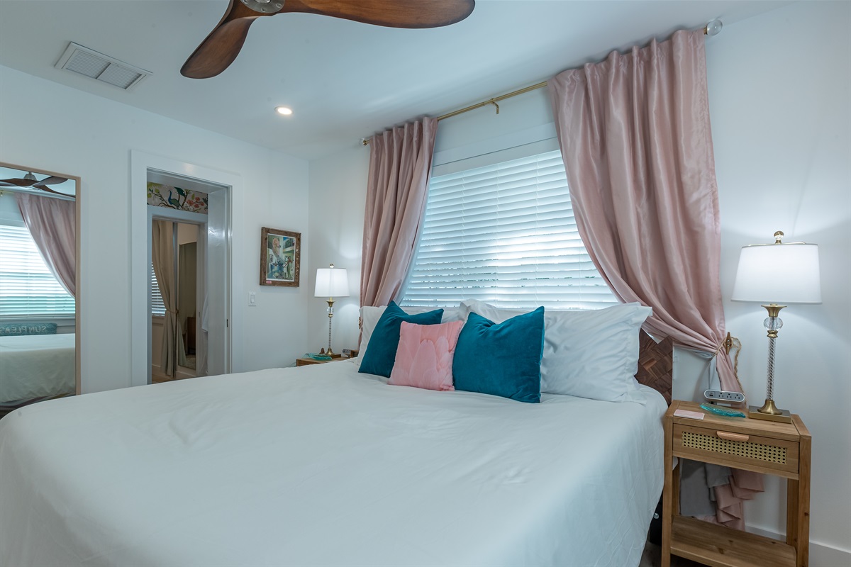 Bedroom Retreat: Relax in a bright, stylish space with plush pillows and soothing decor!