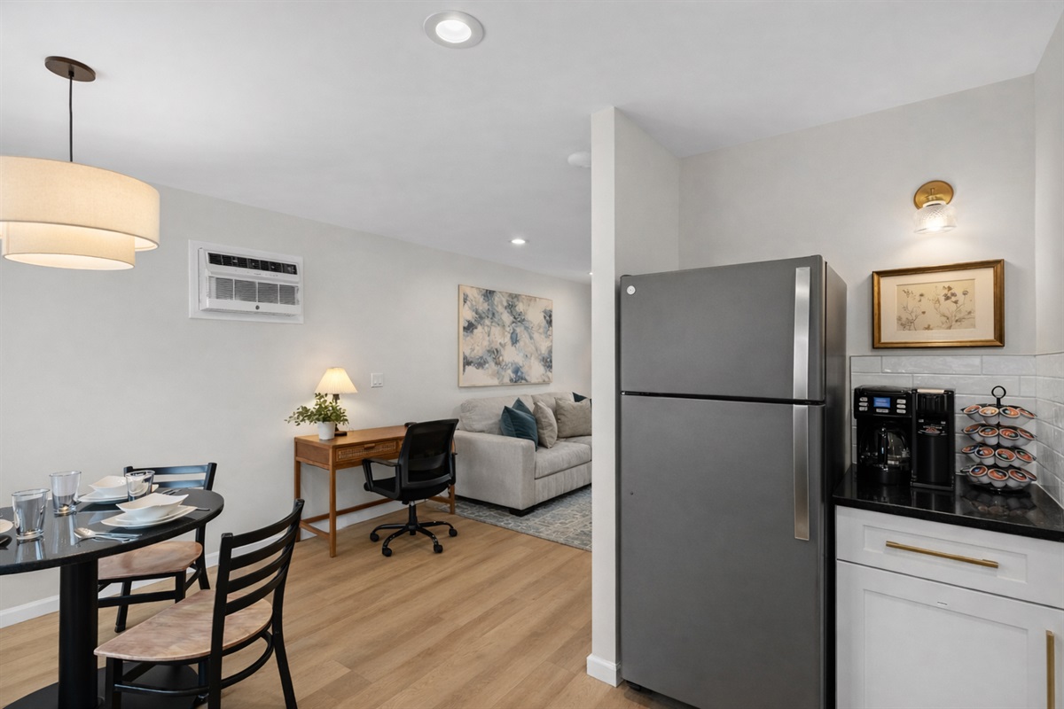 Open-concept layout featuring a modern kitchen, cozy living area, dining nook, and workspace—perfect for comfort, productivity, and longer stays.