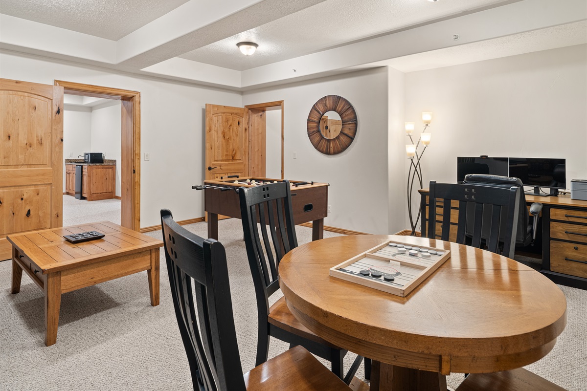 Lower-level living space with table seating and TV area