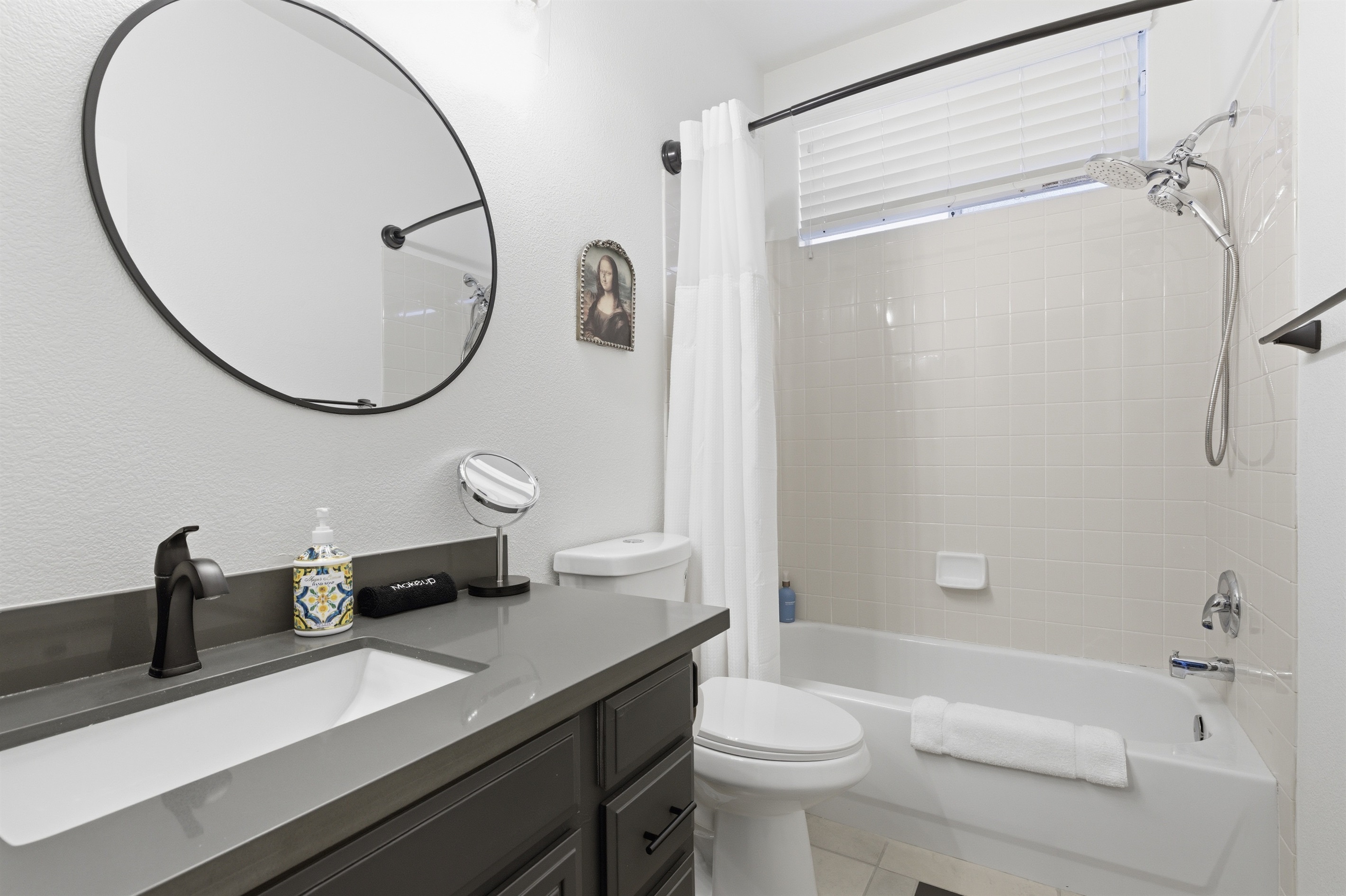 Downstairs hallway bathroom with and a bathtub/shower combo.  The majority of our bathrooms have a double sink.  It's Showtime!