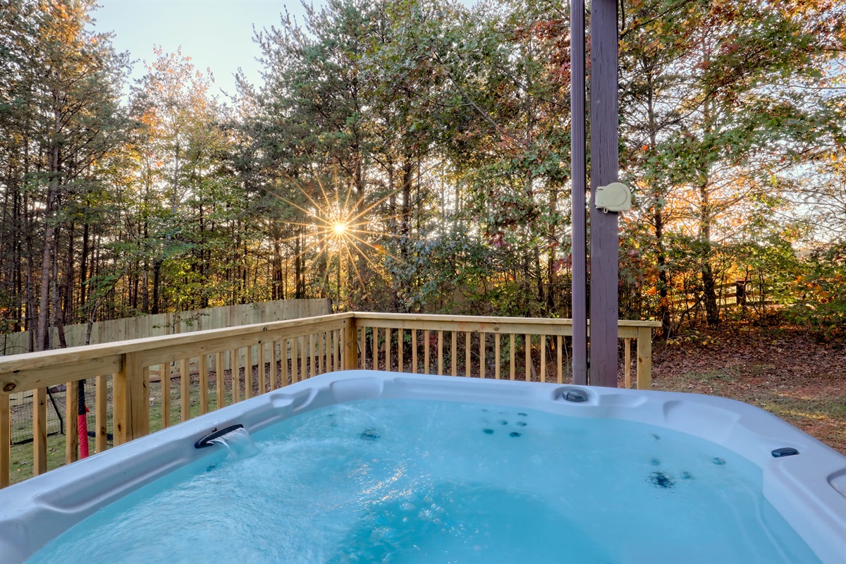 Relax in the hot tub surrounded by peaceful wooded scenery.