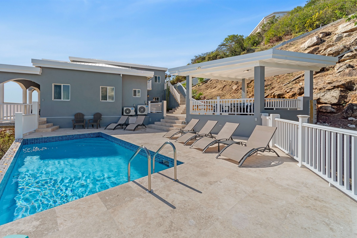 Cool off by the pool or relax under the shaded lounge space.