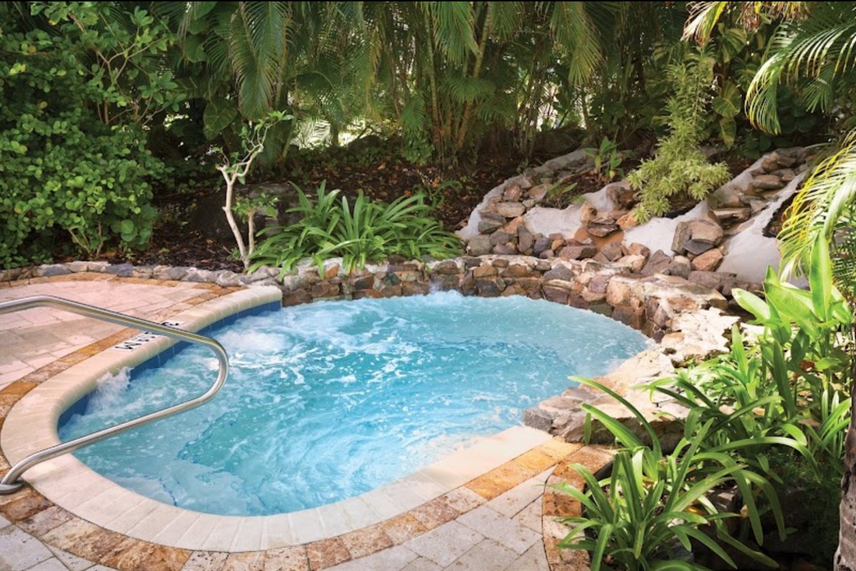 Relax in the bubbling hot tub tucked into a tropical setting for a rejuvenating soak.