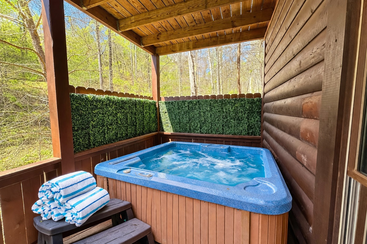 Soak in the private hot tub surrounded by peaceful Smoky Mountain woods