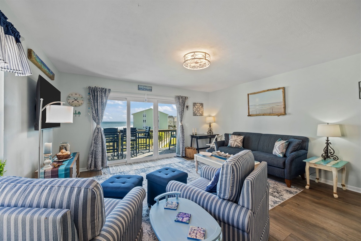 Open-concept living area designed for gathering, with easy flow from seating to balcony views