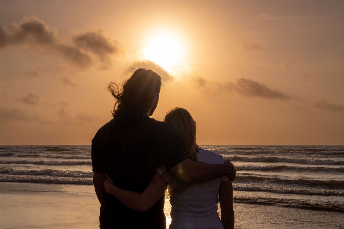 Couple's sunset on the sand — the kind of moment you'll still talk about in February.