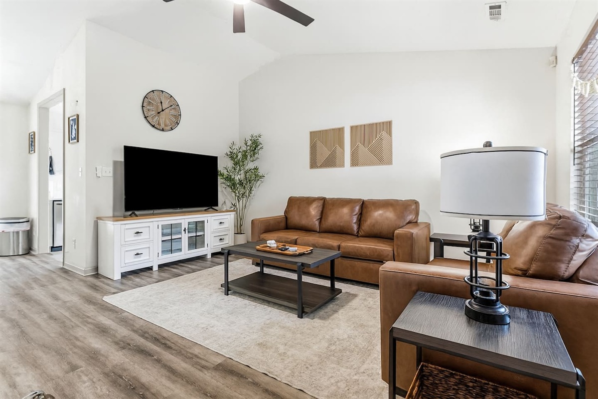 Living Room with 65" Smart TV, dedicated workspace, cards, board games and cozy seating!