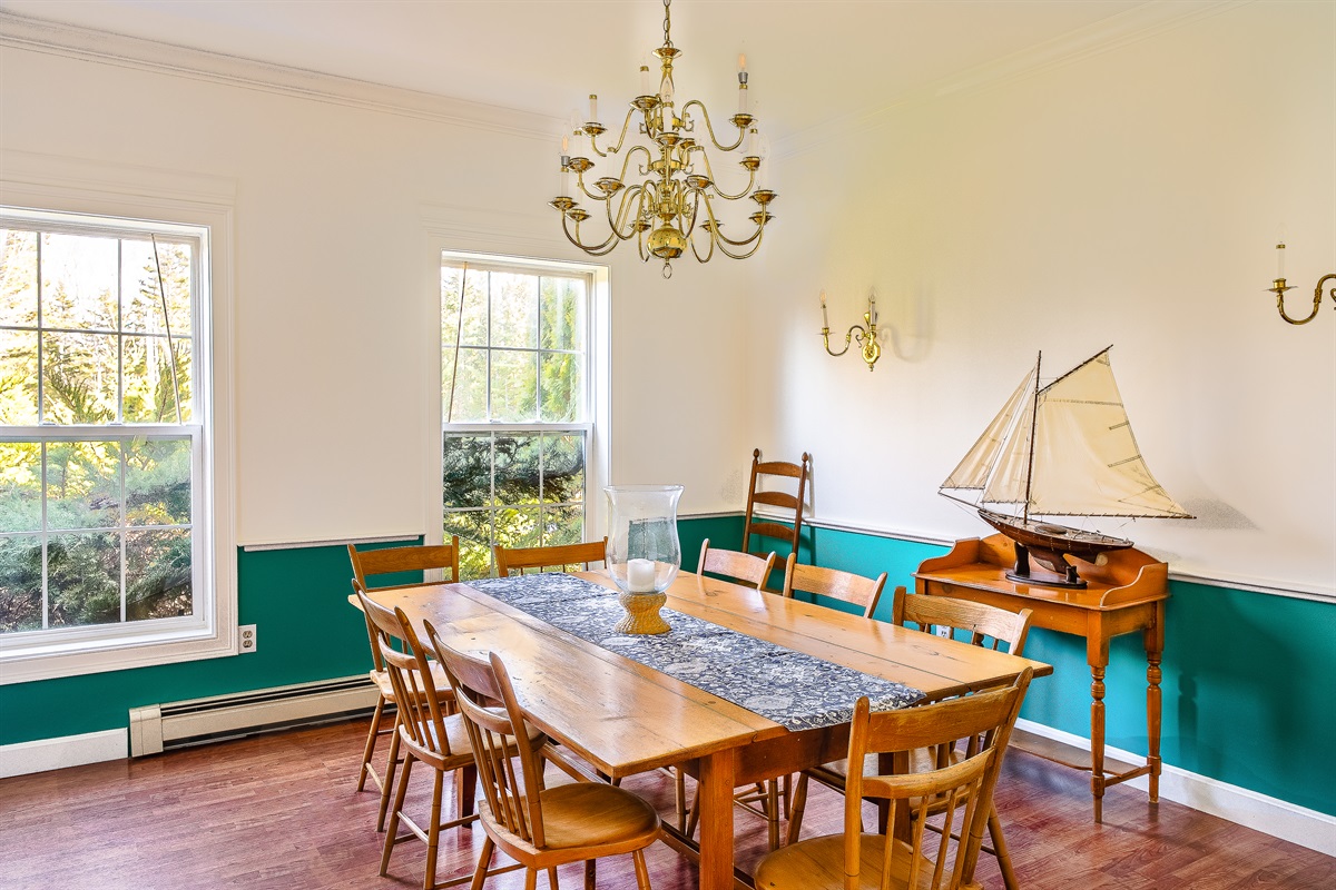 Natural light pours into the formal dining room, viewed here from the kitchen entryway. This convenient flow makes serving group meals easy, keeping the kitchen prep separate while maintaining a connected feel for your Acadia National Park retreat.