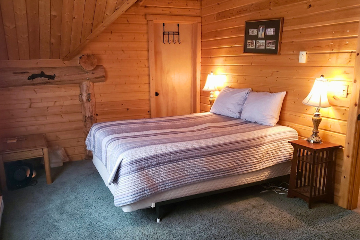 Bedroom 4: provides a comfortable queen bed and beautiful forest views.