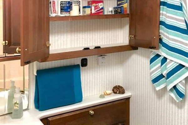 Toilet and Stocked Cabinet