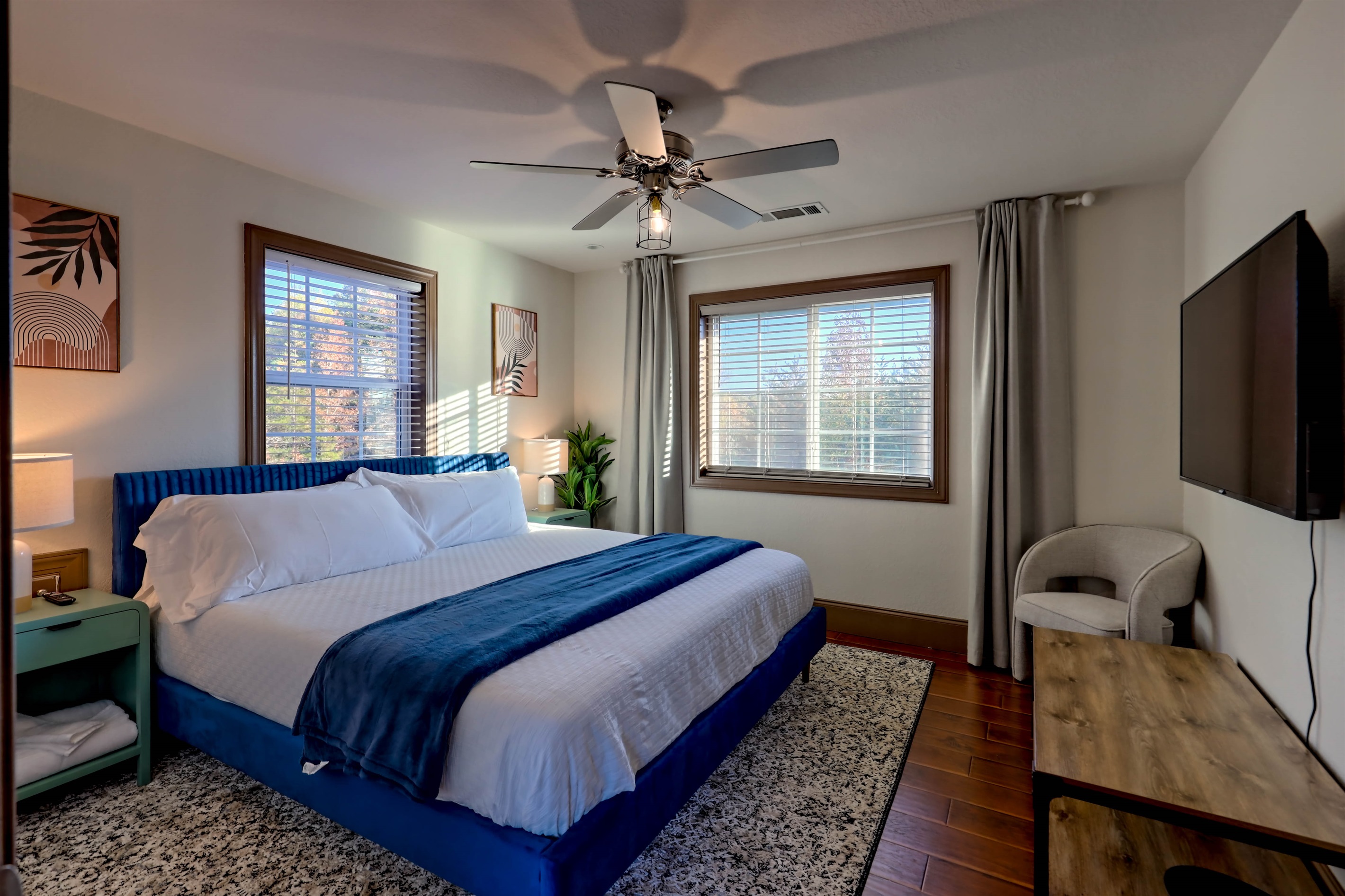 2nd floor king room featuring a large TV and cozy seating.