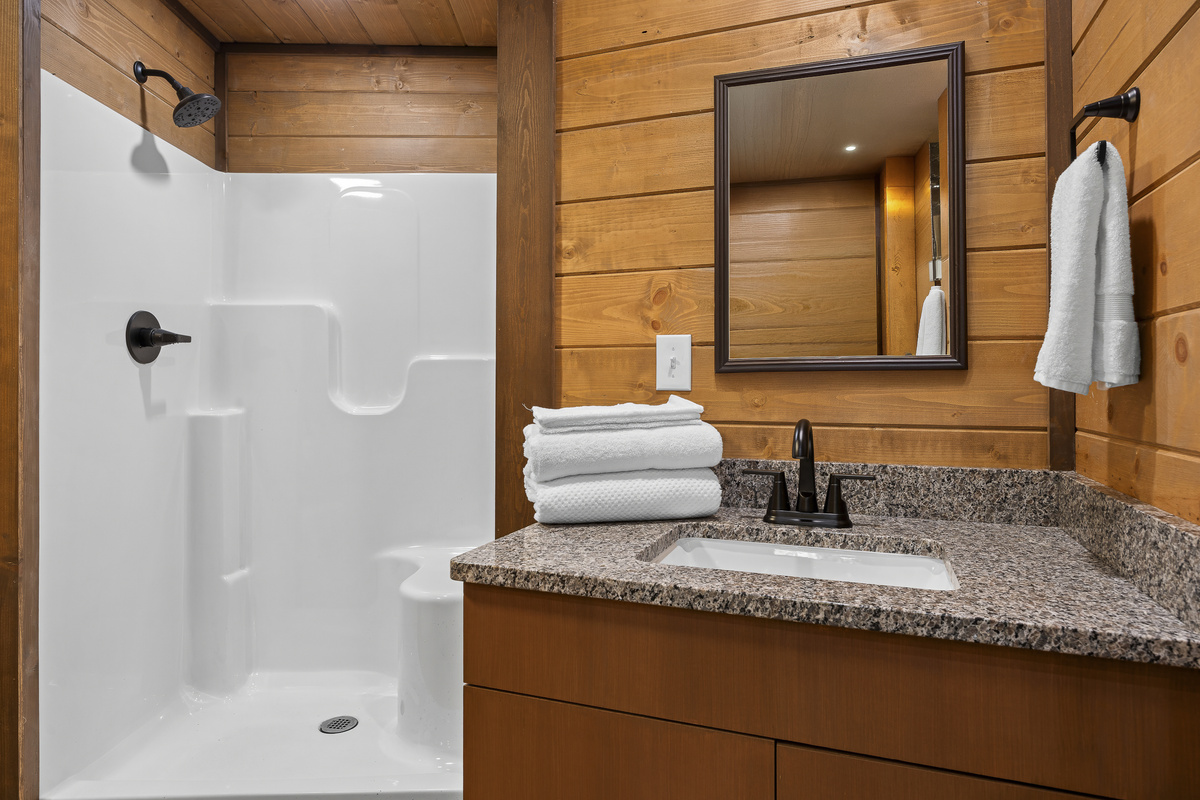 Bathroom Oasis: Enjoy a modern shower and sleek finishes in a rustic wood retreat!