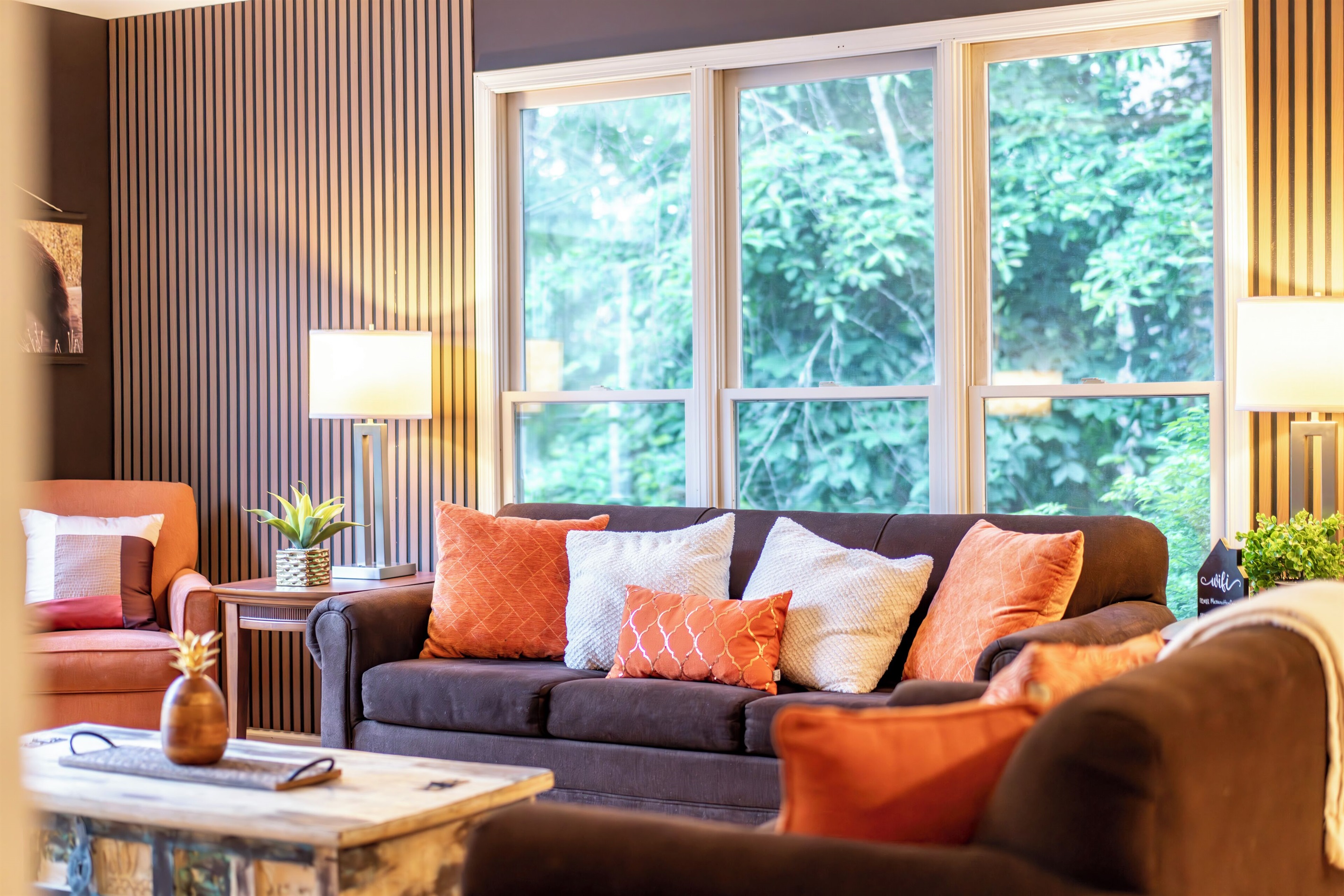 Living room with large TV, electric fireplace, and ample seating

