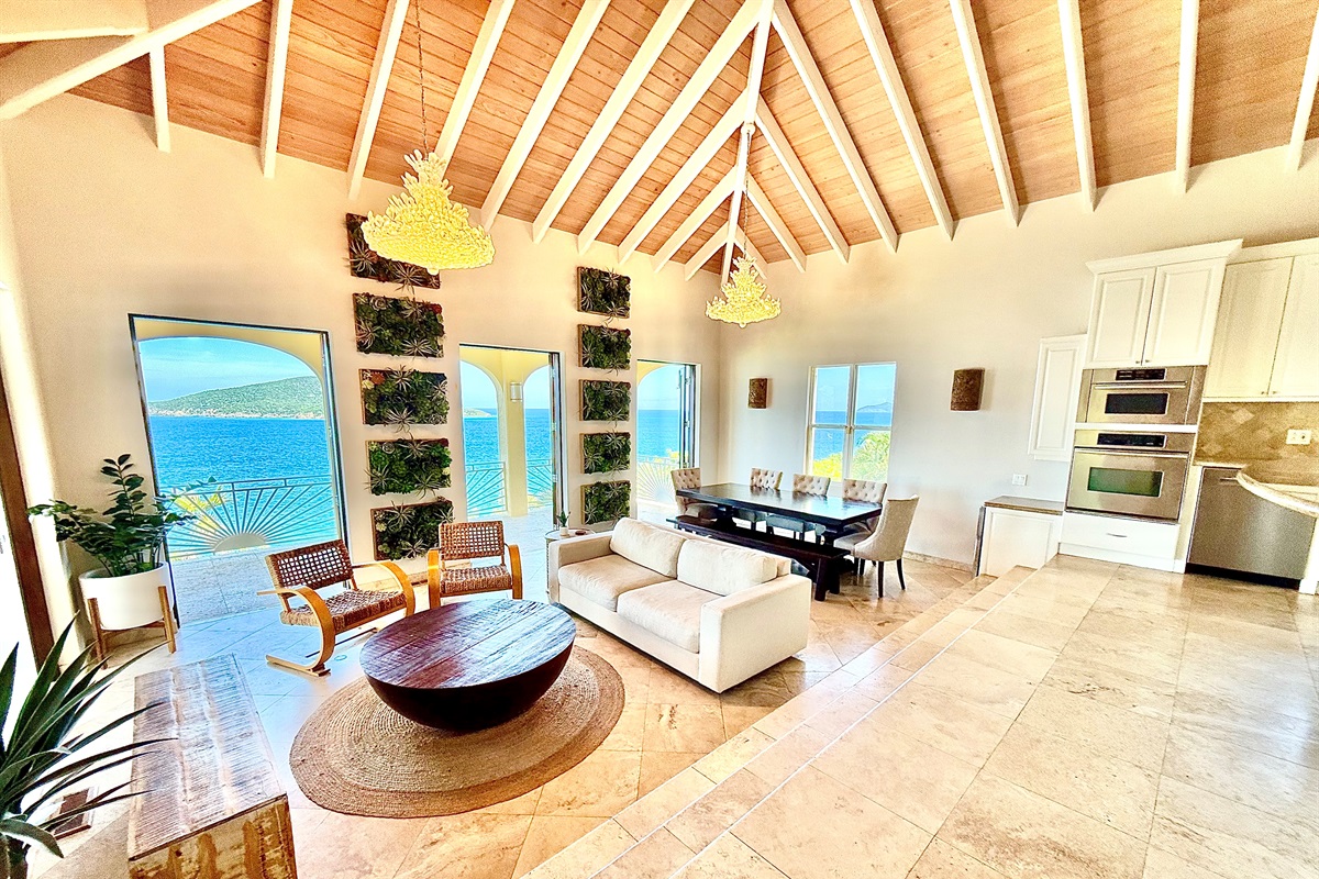 Stunning open-concept great room with vaulted ceilings, chef’s kitchen, and panoramic ocean views.