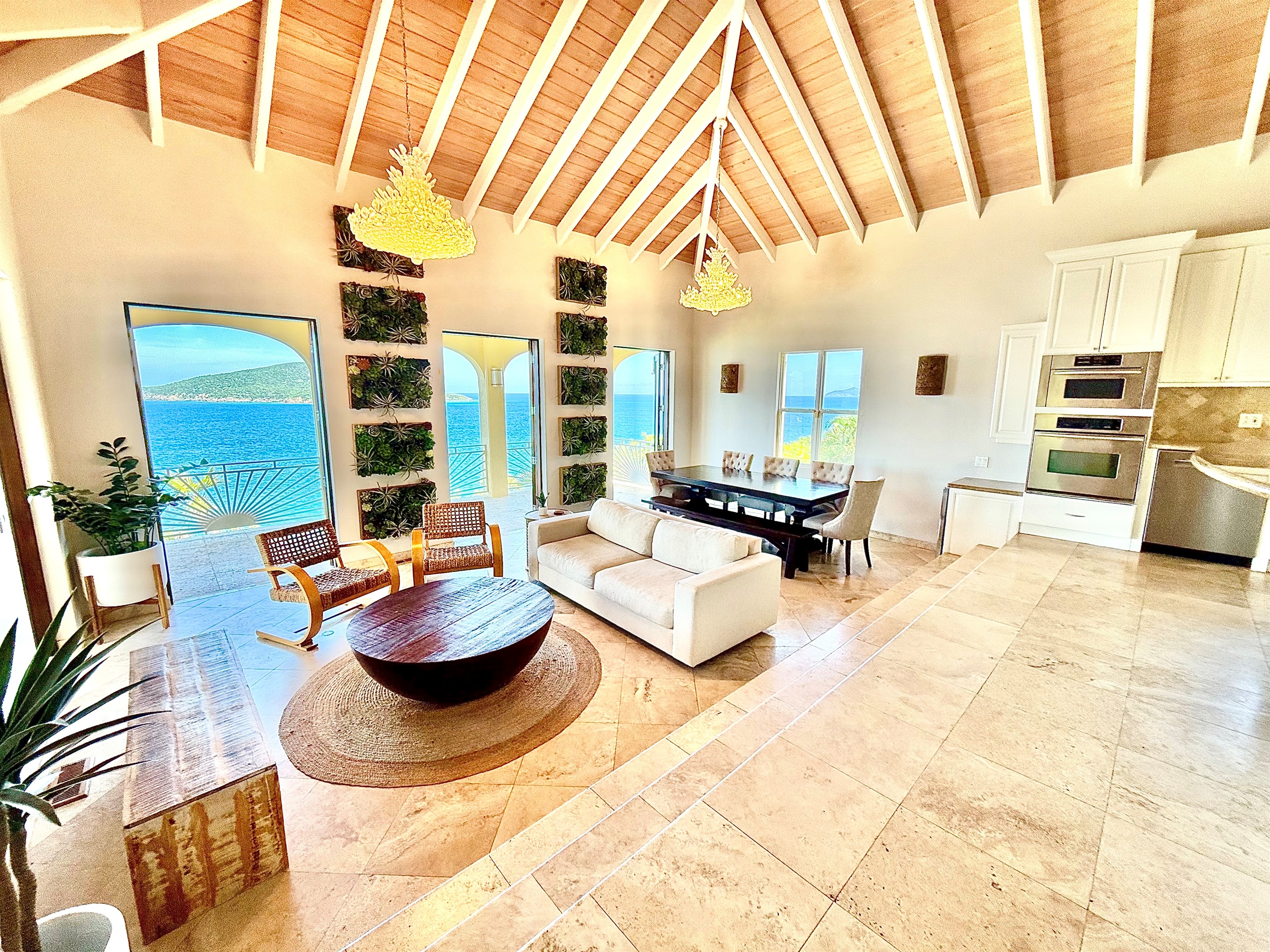 Stunning open-concept great room with vaulted ceilings, chef’s kitchen, and panoramic ocean views.