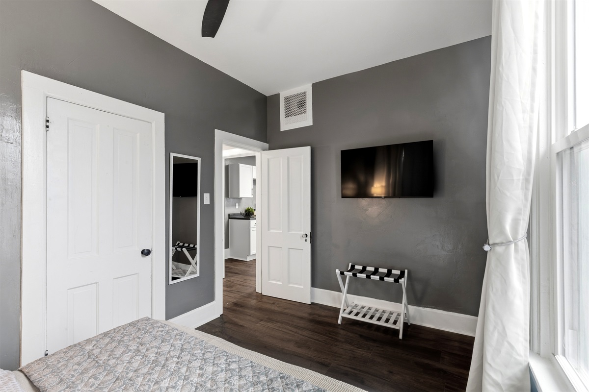 Queen bedroom with smart TV, located directly across from the bathroom.