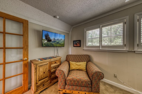 Relax in the bedroom with a comfy couch and a TV for your entertainment — the perfect spot to unwind after a day of adventure!