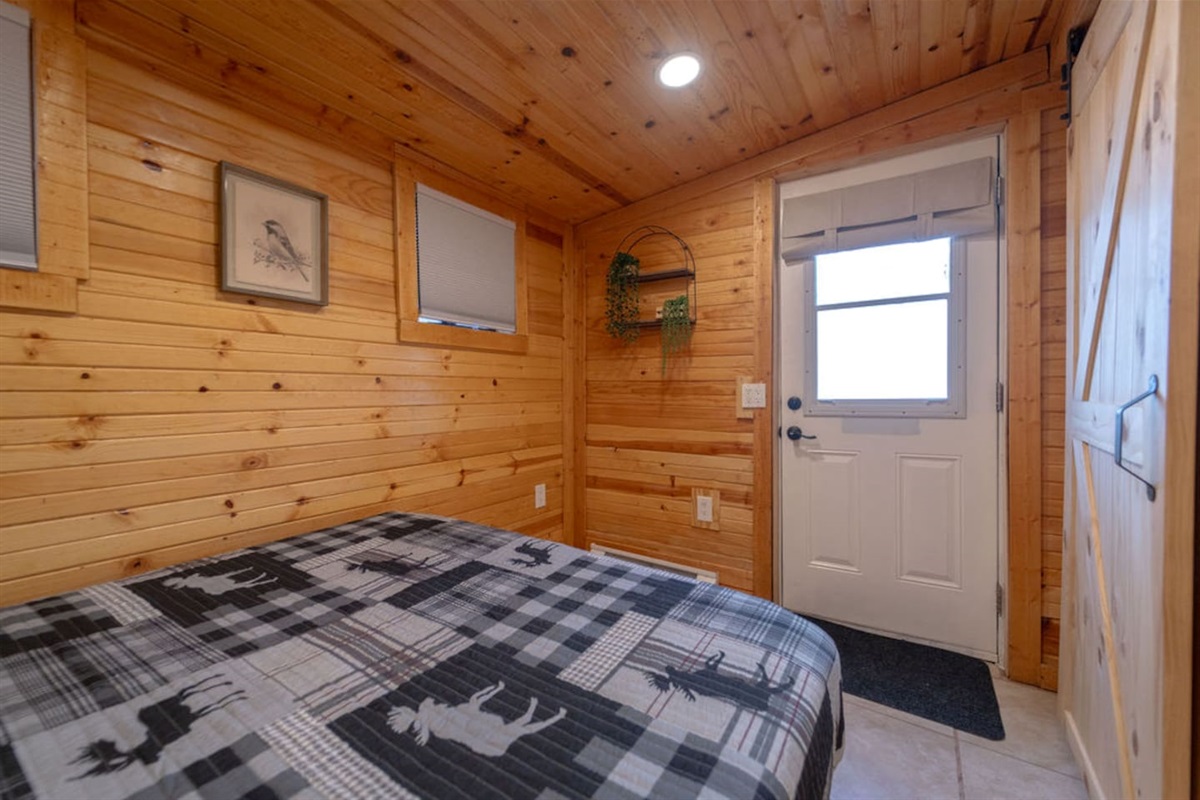 Wake up in this cozy queen bed and step right outside for a breath of fresh air! With a door leading to the backyard, you’re just a step away from nature—perfect for a quiet moment before your next adventure.