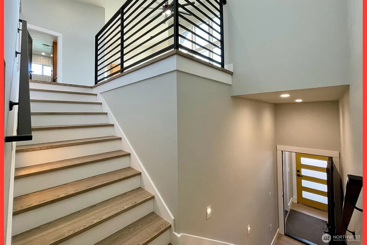The entry sets the tone — a designer staircase and modern railings bring architectural style from the moment you walk in.