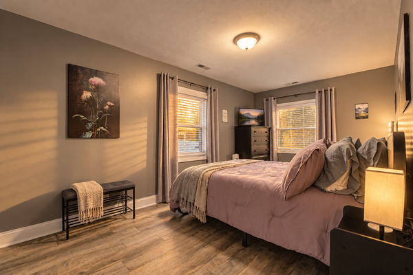 Bedroom 1 with a queen bed, fresh linens, smart TV and closet storage. Private bedroom in the house.