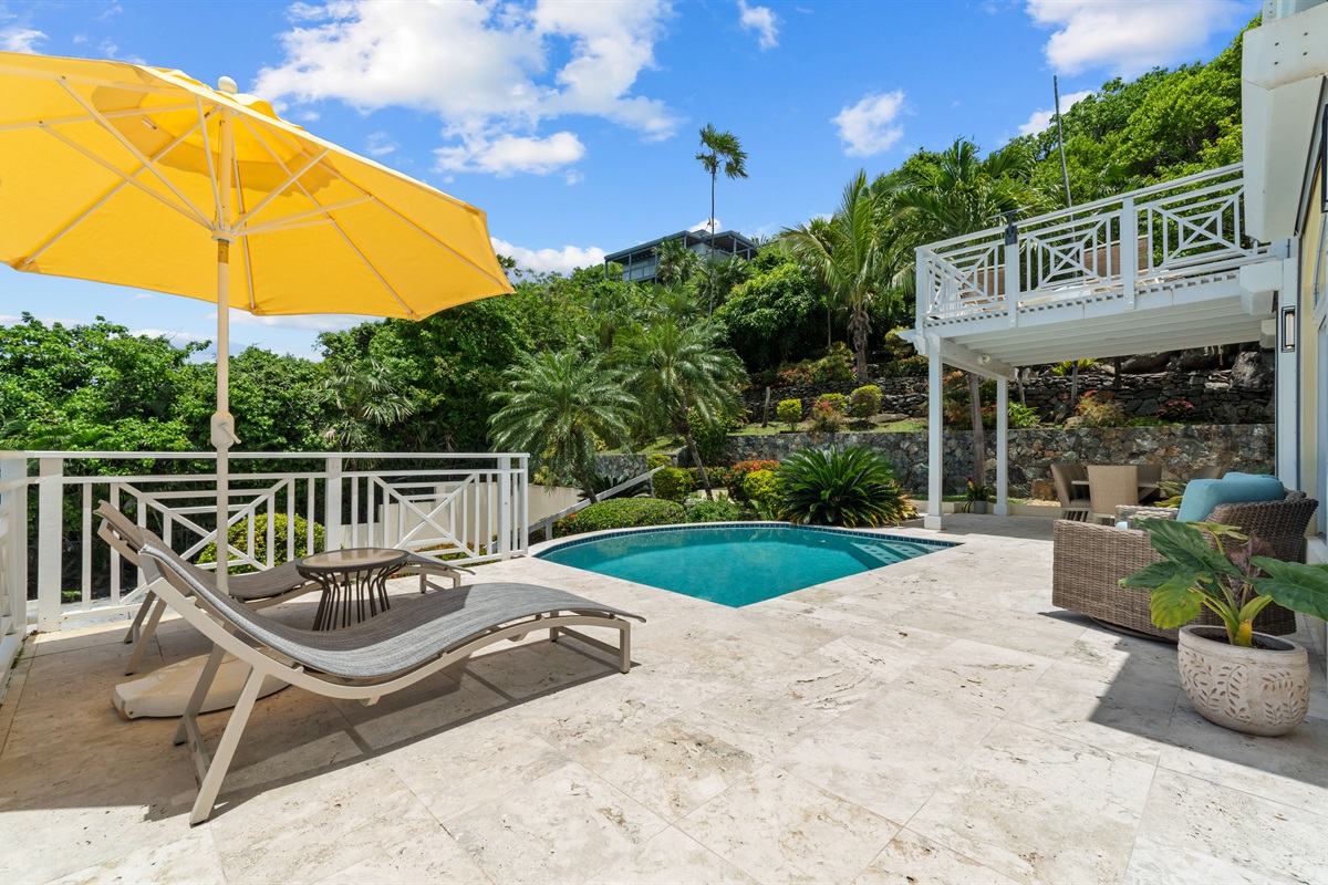 Open-air space with pool views and casual seating, hang out, catch a breeze, or toast to vacation mode.