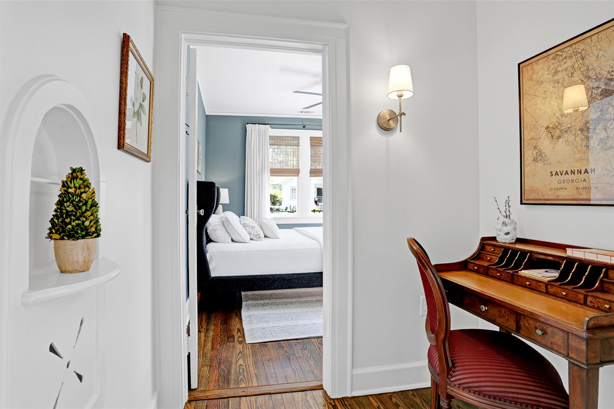 A cozy desk tucked in the hallway offers a quiet spot to focus, work, or read.