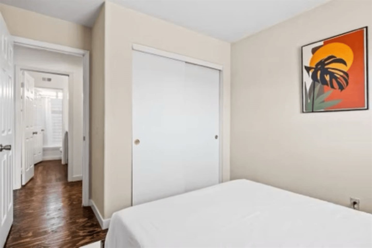 Peaceful bedroom with bed linens, essentials, and natural light, creating a cozy and relaxing place to unwind.
