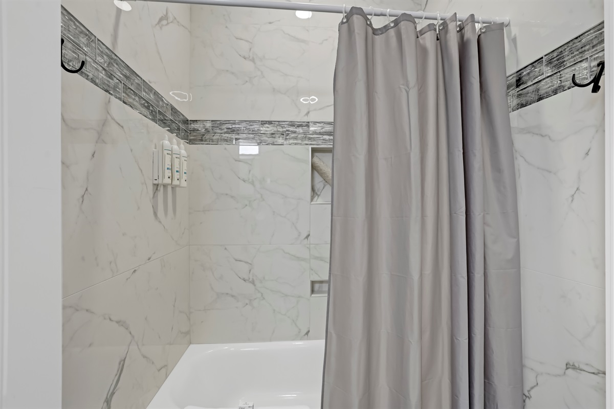 A classic tiled tub/shower combo offers both convenience and charm.