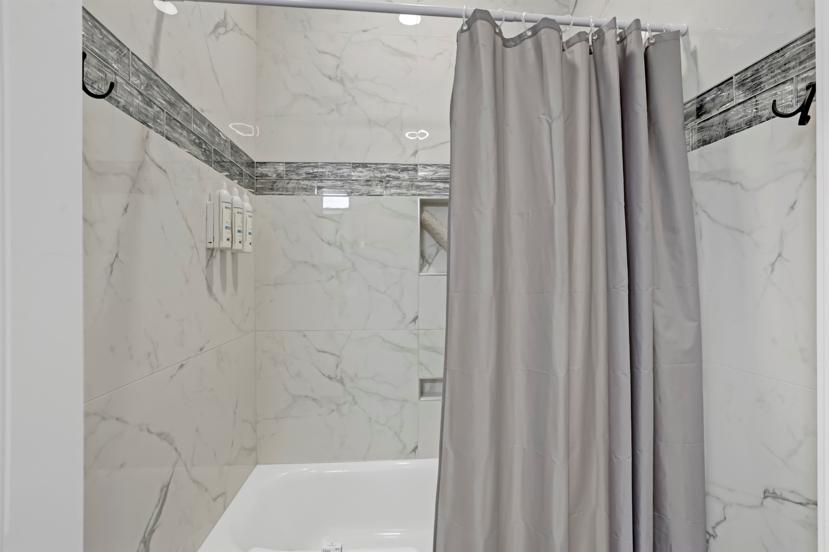A classic tiled tub/shower combo offers both convenience and charm.