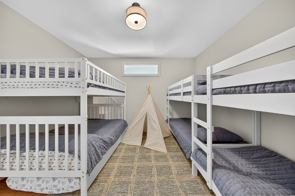 The ultimate kids’ hangout—bunk beds, doubles, a twin, and even a teepee for adventures!
