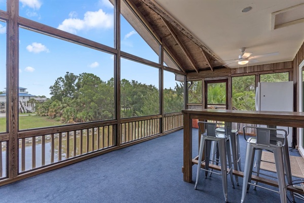 Canal Screened Porch with outdoor seating, bait fridge, and drinks fridge