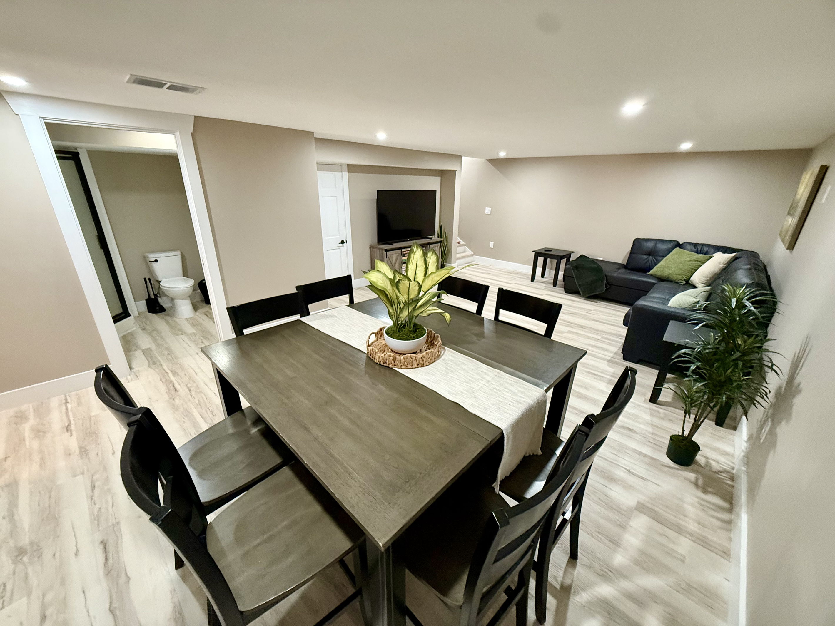 Dining area and family room with 65” Roku Smart TV