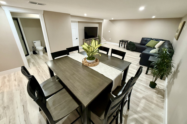 Dining area and family room with 65” Roku Smart TV