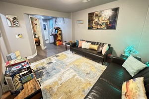 Our living room is all about relaxation, with plush couches, a TV for bonding, and an arcade for hours of gaming excitement!