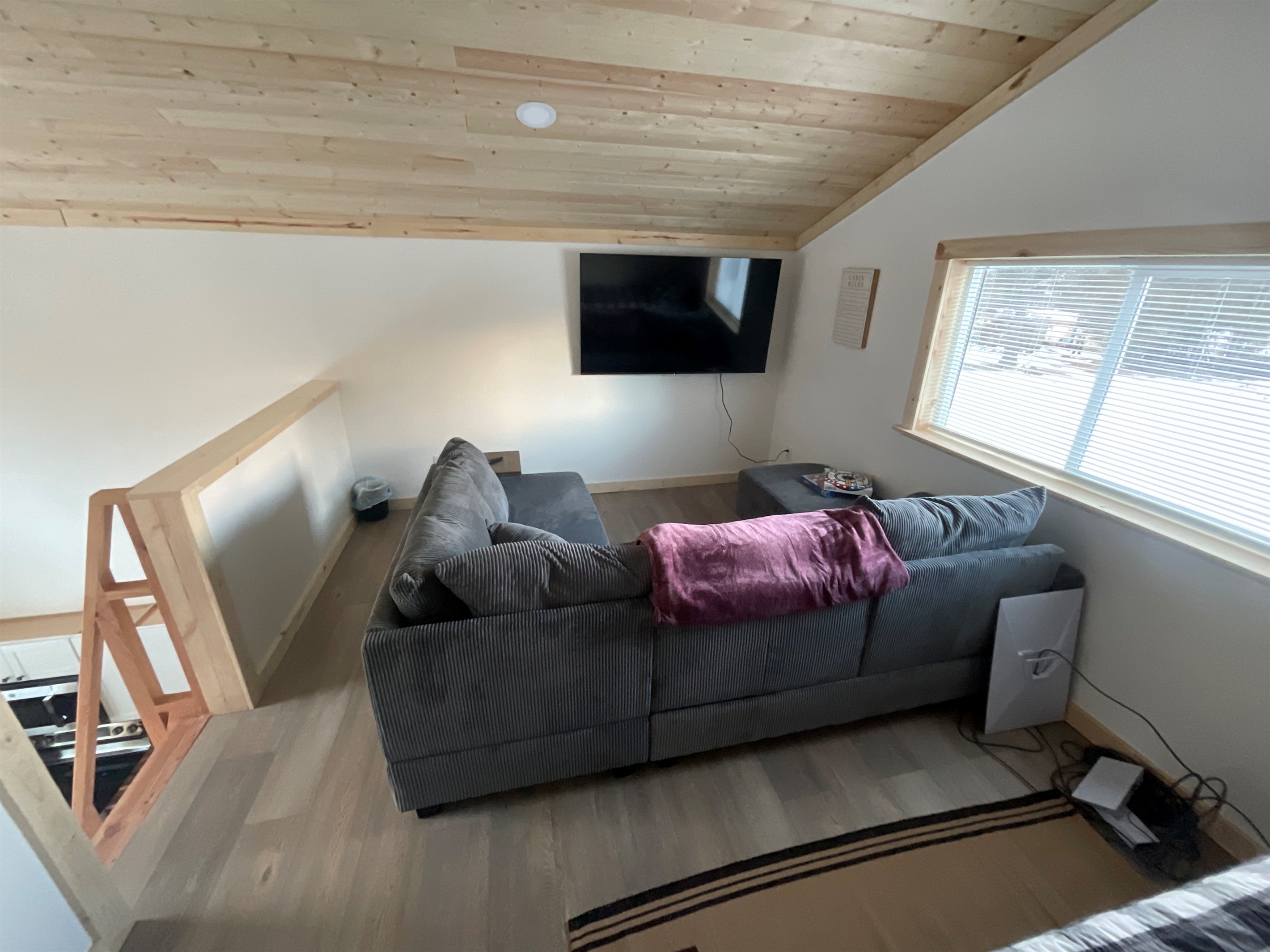 Loft living area - sectional sofa and big screen TV.