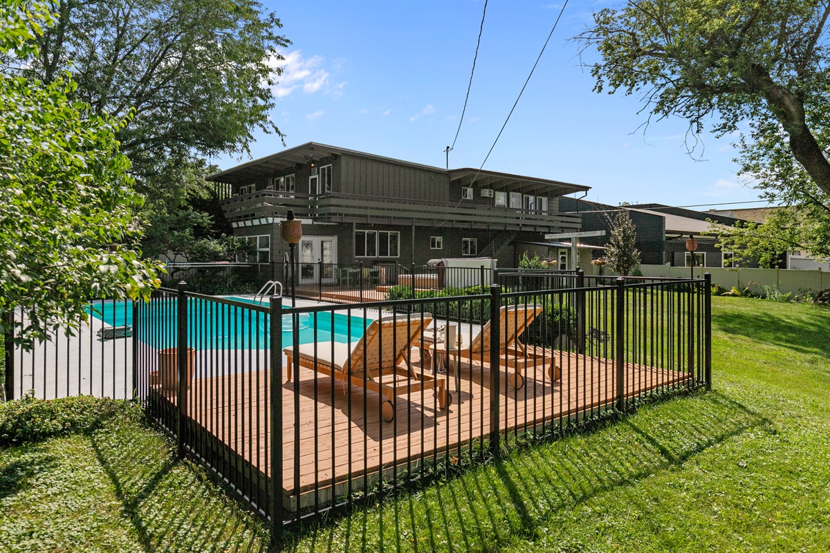 The grassy yard is perfect for pups to stretch their legs and play, making it a welcoming space for your four-legged family member.