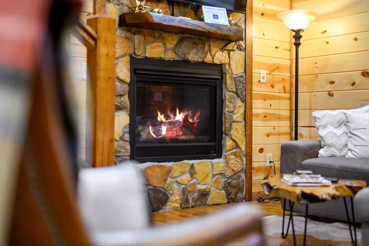 Living Room: Gather around the stone fireplace and enjoy warm evenings in style!