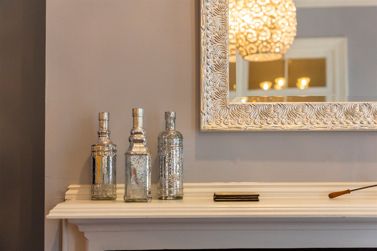 Thoughtful touches and curated décor highlight the historic fireplace, blending old-world charm with modern style.