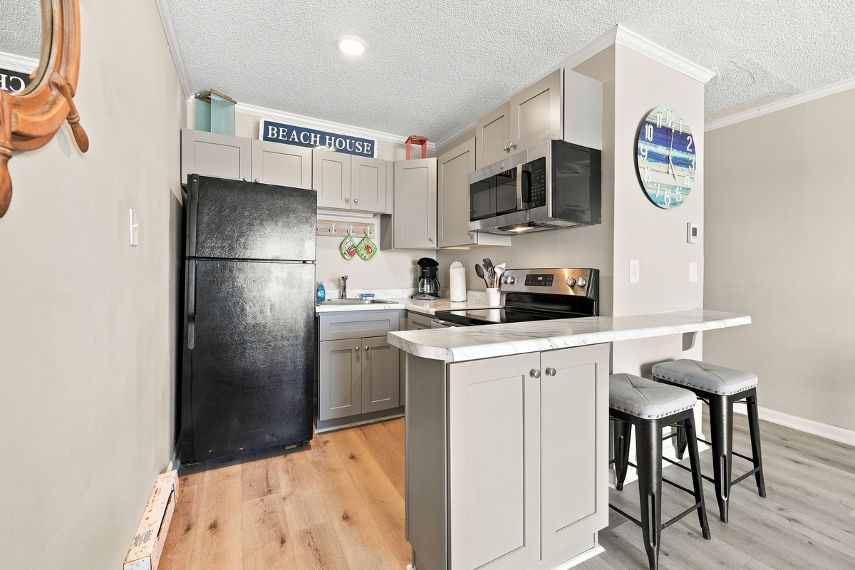 Cook, gather, and enjoy vacation meals in the updated kitchen with modern appliances and a functional layout