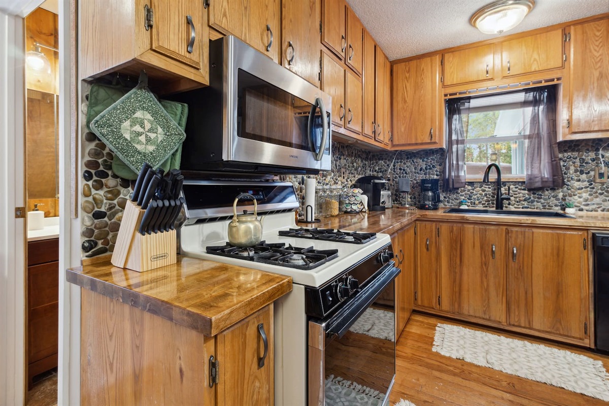 Keurig, coffee pot, gas stove, and utensils! Enough dishes to serve 8!