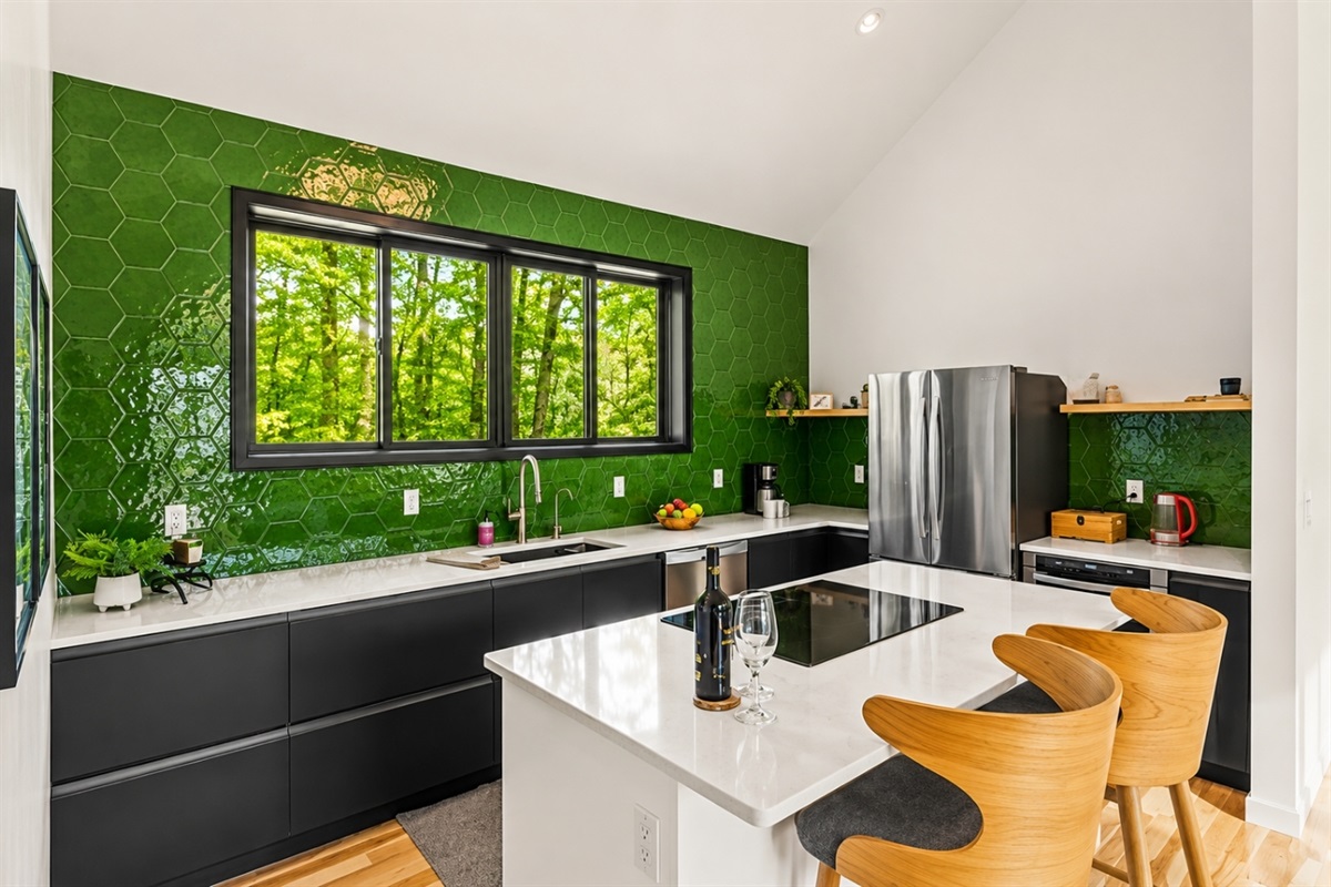 Experience a vibrant, refreshing kitchen where nature meets modern design. This stunning space features a bold green accent wall that brings a sense of calm and rejuvenation to the heart of your home. 