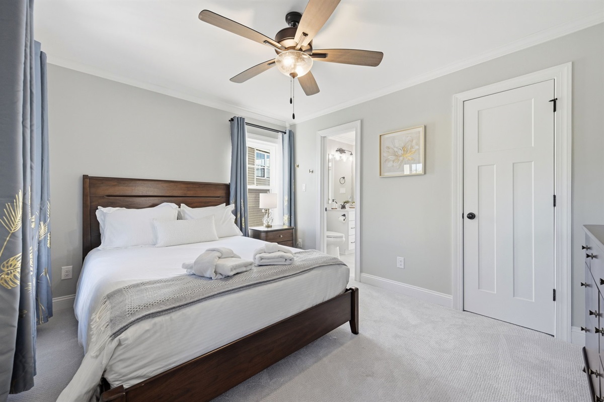 Comfortable first-floor queen bedroom #2 with elegant finishes and a private ensuite bathroom