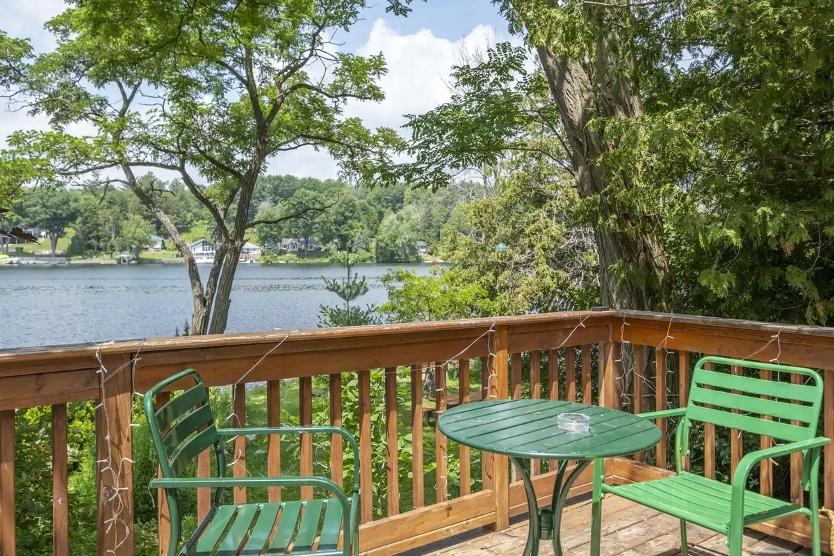 Elevated deck overlooking mature trees and waterfront scenery