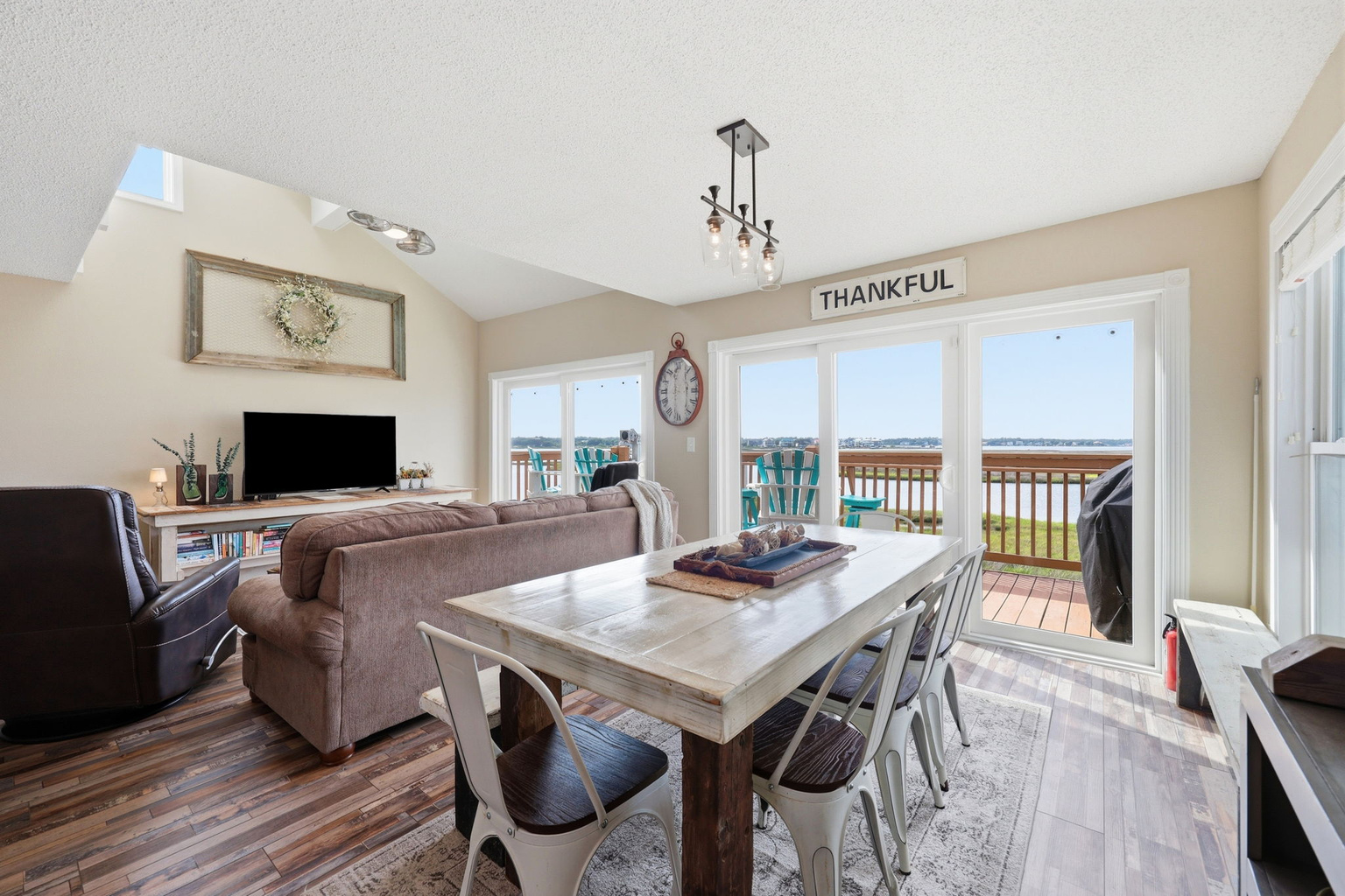 A large dining table that seats 8 and where every meal comes with a coastal backdrop.