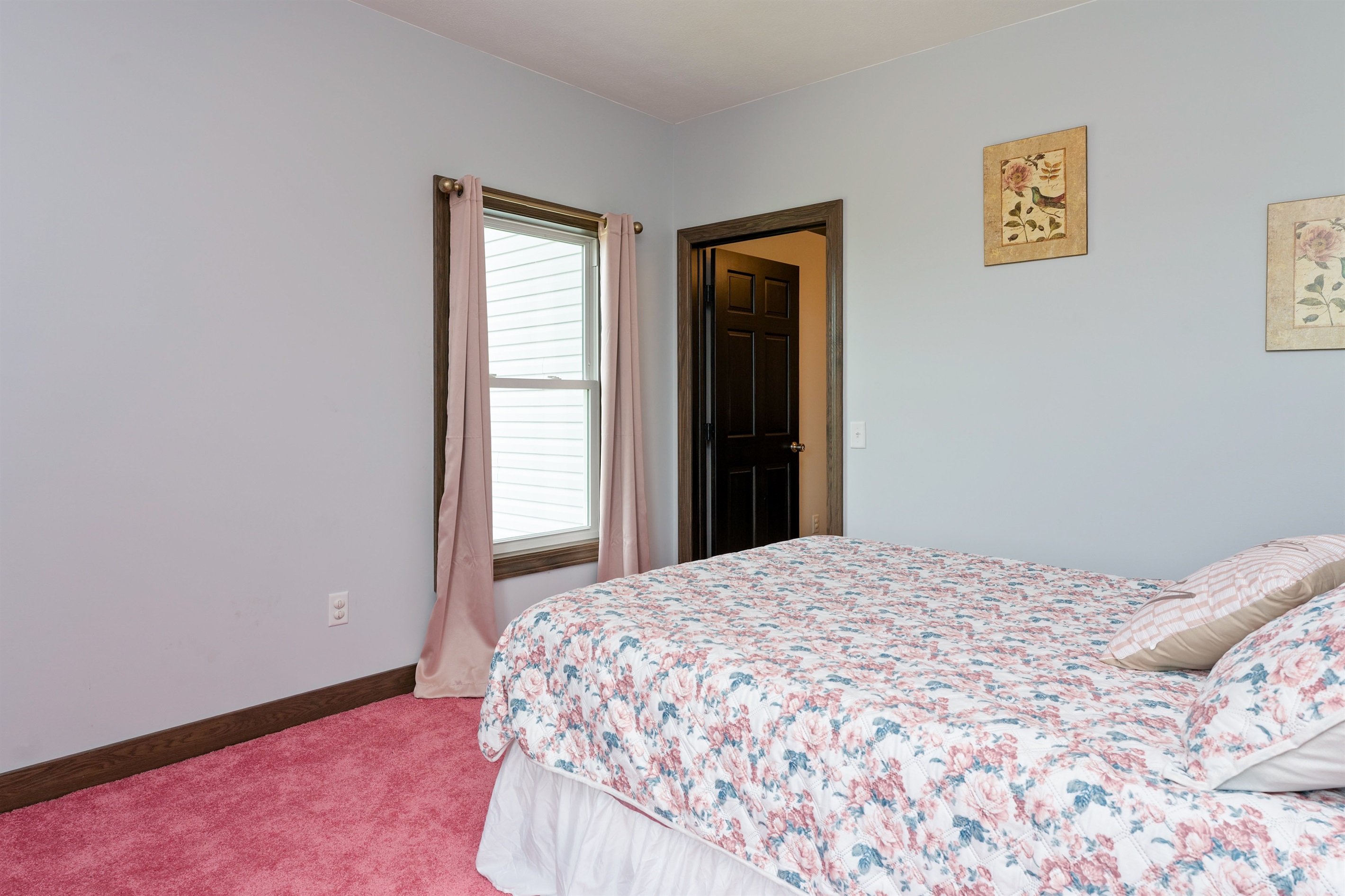 Peaceful Queen bedroom retreat with floral bedding, elegant wood furniture, and delicate wall art creating a warm, restful ambiance. Bedroom #2