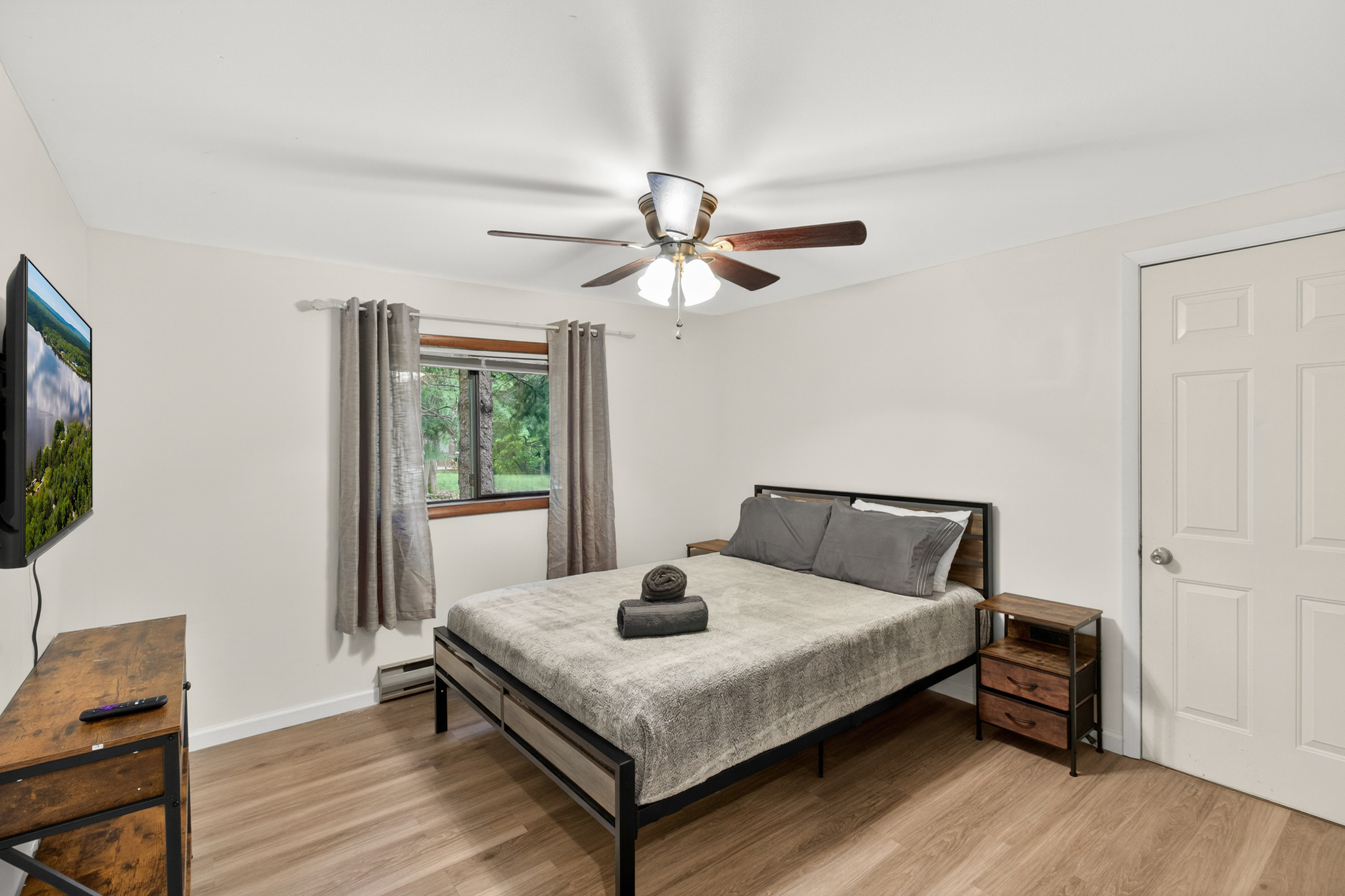 Bedroom with queen bed and Roku TV, on first floor