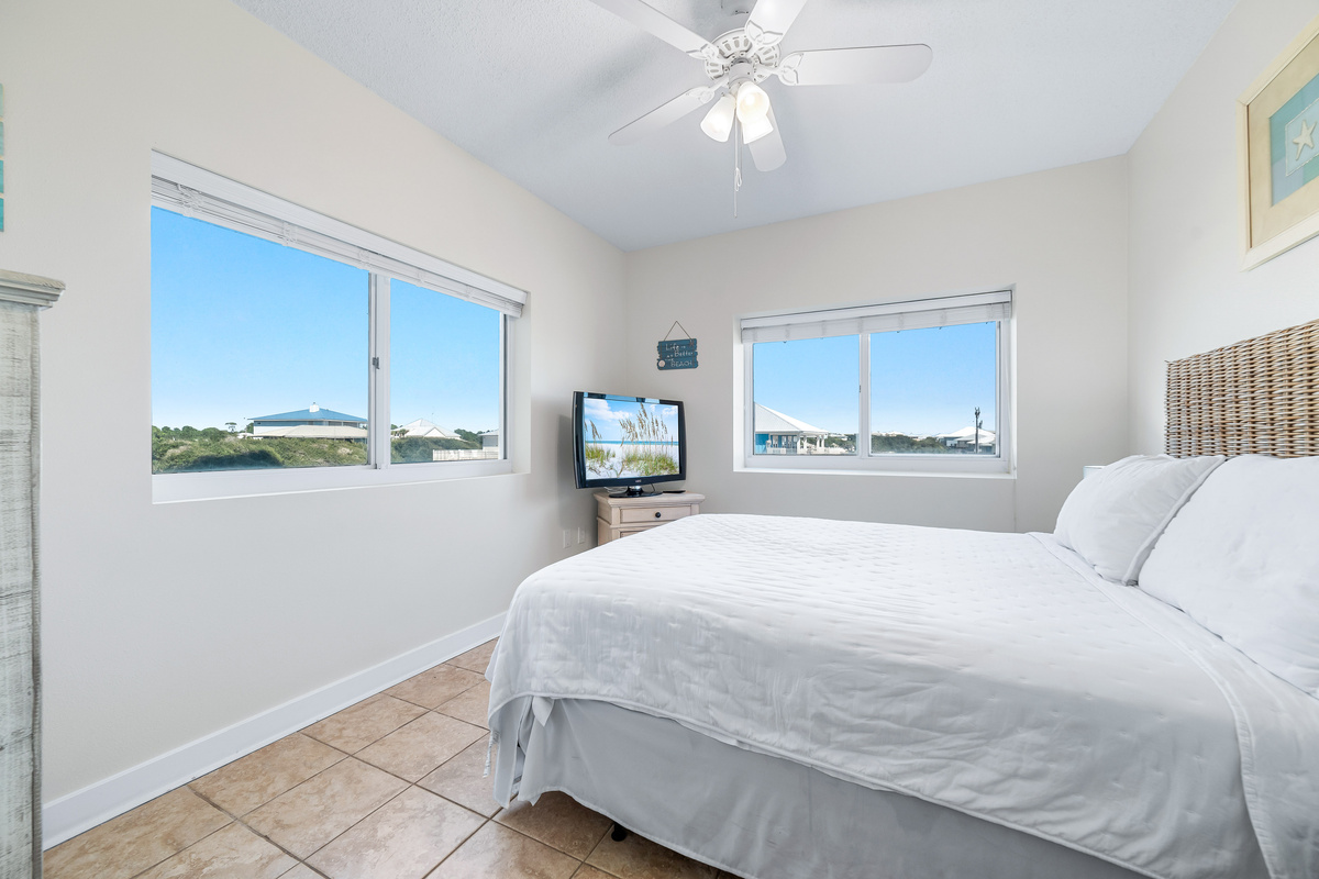 A tranquil Queen Guest bedroom retreat, bathed in natural light and designed with a soothing coastal palette.
