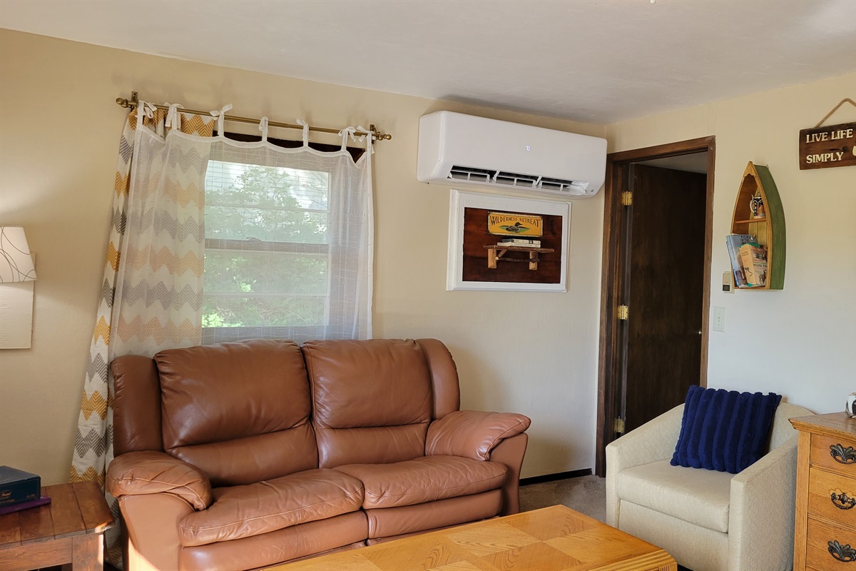 the other side of the living area, and entrance to bedroom